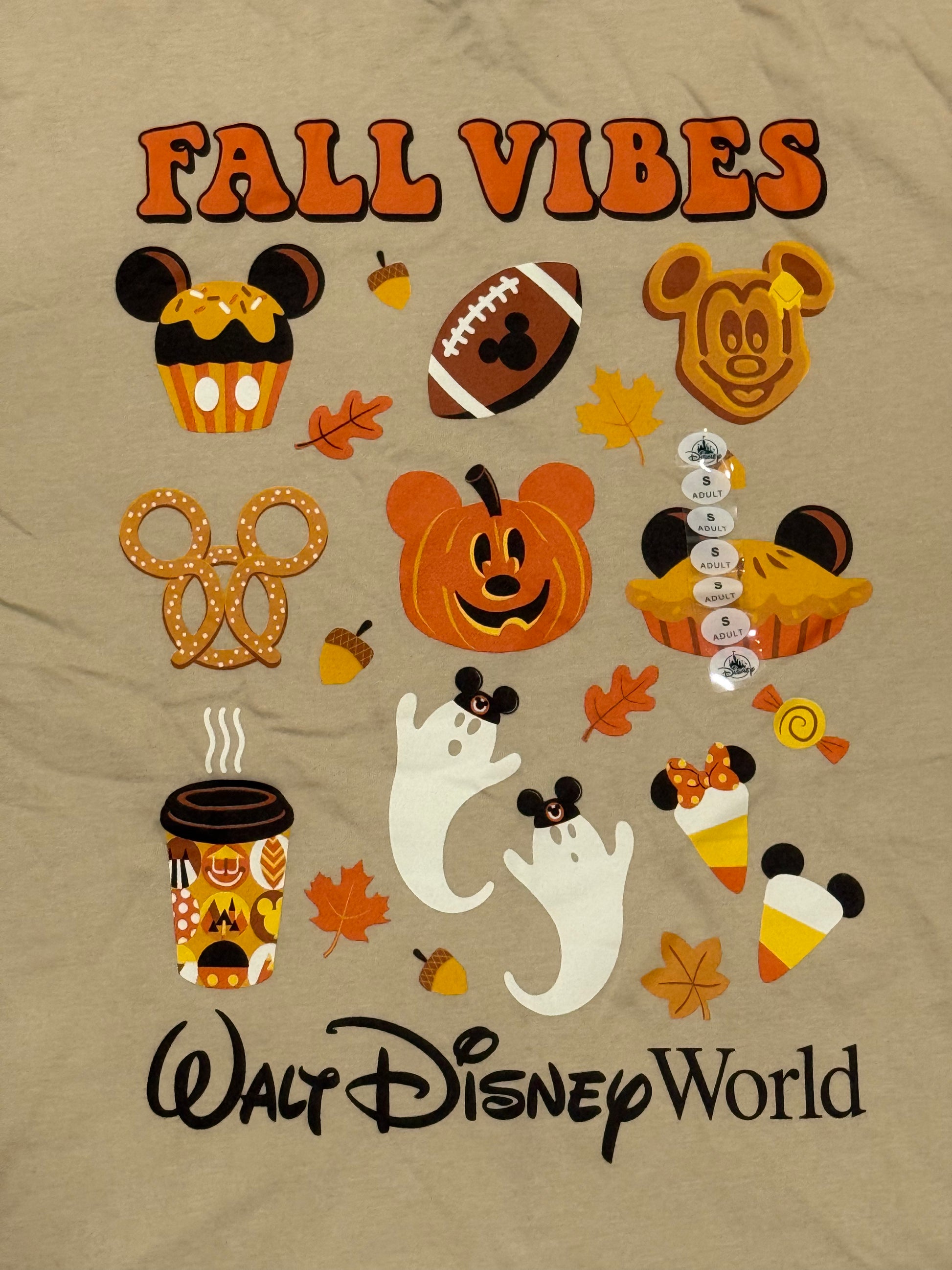 T-shirt with fall-themed designs and 'Walt Disney World' text on a beige background